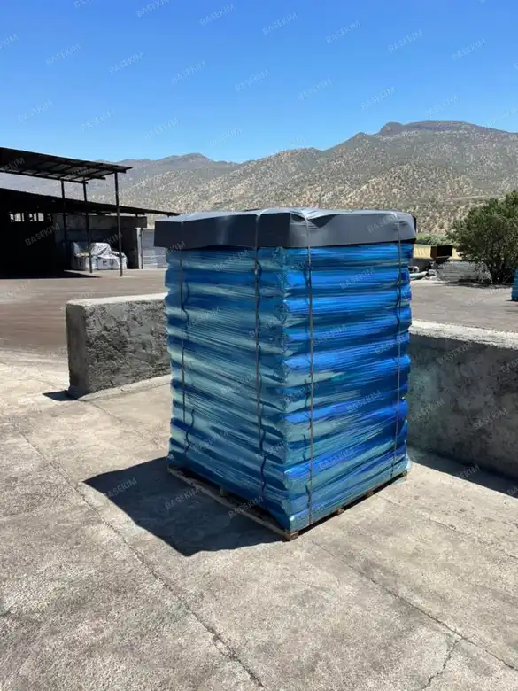 Gilsonite pallets stretch-wrapped in blue film – sealer & filler application