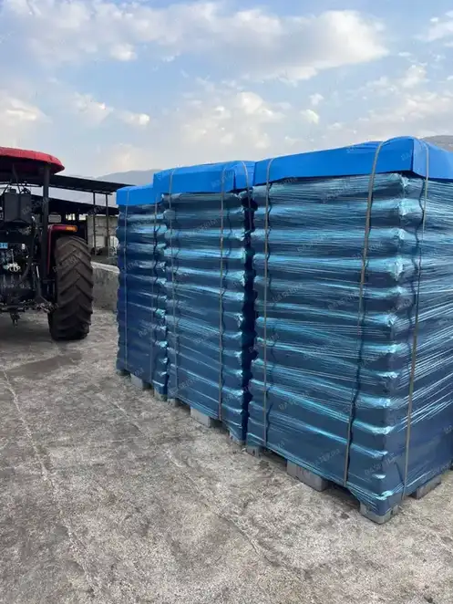 Gilsonite pallets stretch-wrapped in blue film